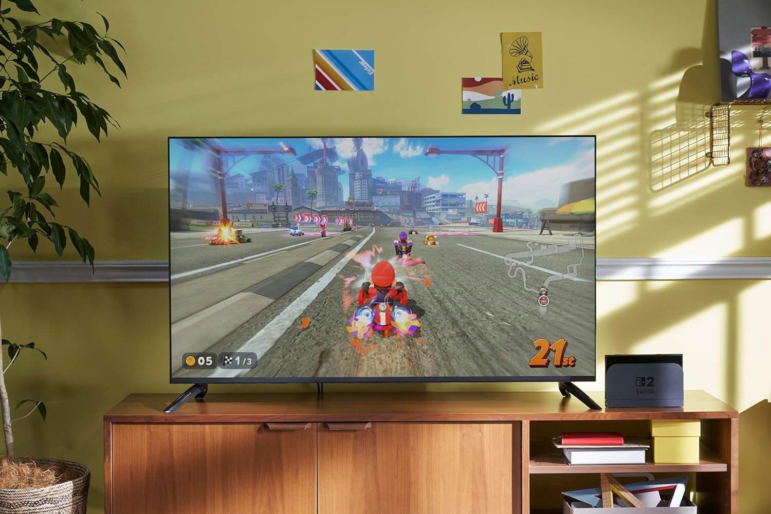 Console Nintendo Switch 2 displaying Mario Kart gameplay on a large screen in a stylish living room.